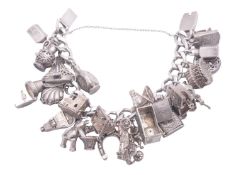 A silver curb-link charm bracelet, fitted with various silver and other white metal charms;
