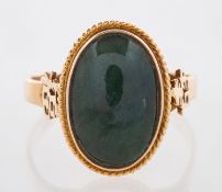 A nephrite jade ring and earrings, the ring features an oval jade cabochon