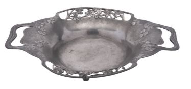 An Art-Nouveau two-handled pewter dish, with pierced sides and decorated in relief with clovers,