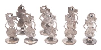 A set of eight 20th century Balinese menu card holders, in the form of Wayang puppets,