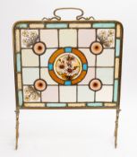A Victorian brass and stained glass fire