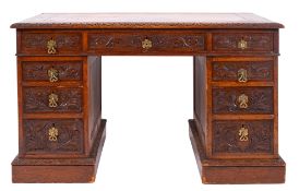 A Victorian carved oak pedestal desk, la