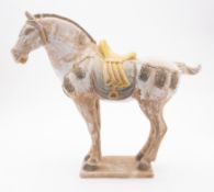 A pottery figure of a caparisoned horse
