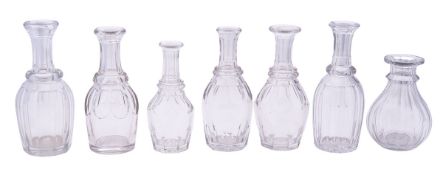 Seven heavy cut glass water bottles of v