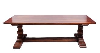 A cherrywood trestle dining table, second half 20th century; the rectangular top with cleated ends,
