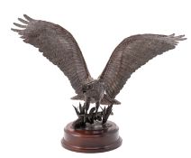 A patinated metal model of a fish eagle,