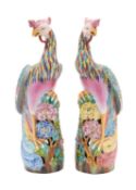 A pair of Chinese porcelain phoenix perched atop a flowering chrysanthemum branch,