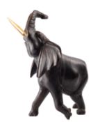 A carved and stained hardwood model of an African elephant,