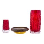 Three pieces of British art glass comprising a Whitefriars Bark vase in ruby red and a Coffin vase