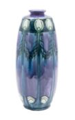 A Minton Seccessionist vase of shouldered oviform slip trailed with feather and swag motifs in blue,