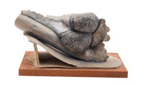 A stoneware sculpture by an unknown hand mounted on a wooden plaque, 36cm long.