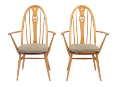 Two beech and elm elbow chairs by Ercol, mid 20th Century.