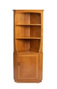 A blonde elm corner cupboard by Ercol, mid 20th Century.