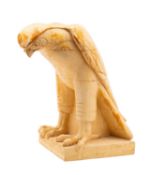 A contemporary stoneware figure of a hawk, modelled standing on a faux wooden base,