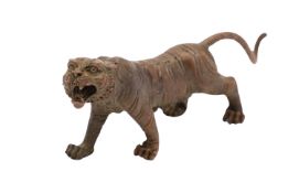 A cold painted metal model of a tiger, early 20th century; naturalistically portrayed walking,