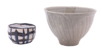 *Jeremy Leach [b 1941] a white stoneware bowl with fluted decoration under a pale celadon glaze,