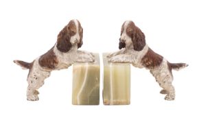A pair of Continental cold painted bronze and onyx mounted bookends modelled with spaniels,