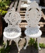 Two white painted iron garden chairs, in