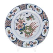 A Bristol polychrome delftware charger, mid 18th century painted with flowering stems, grasses,