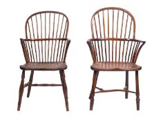 Two similar elm and yew Windsor elbow chairs, 19th century; with arched spindle backs,