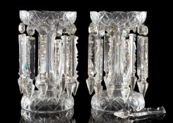 A pair of cut glass table lustres of typical form with bulbous stems and hung with prisms and