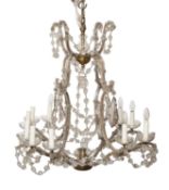 A gilt metal and moulded glass twelve light chandelier,