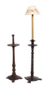 A Continental turned walnut candlestand, 19th century; the socket with metal liner,