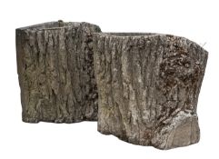 A pair of stone composition garden planters modelled as tree trunks,
