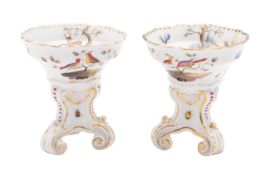 A pair of Meissen porcelain salts set on three scrolling feet and enamelled with deer and exotic