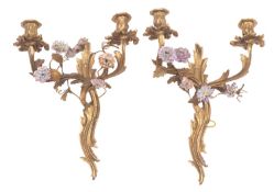 A set of four gilt bronze and porcelain adorned twin-light wall appliques, in Louis XV style,