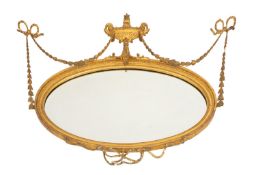 A giltwood and composition framed oval wall mirror, in Adam Neoclassical taste,