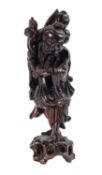 A Chinese carved hardwood figure of an Immortal,