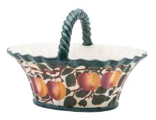 A Robert Heron & Sons Wemyss Ware basket of oval fluted form with rope twist handle decorated with
