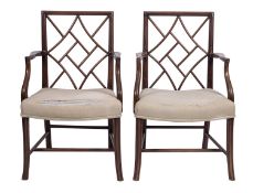 A pair of stained hardwood and upholstered elbow chairs in Chinese Chippendale style,
