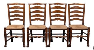 A set of six oak and rush seated ladder back dining chairs, in 18th century style,