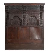 A relief carved oak headboard,