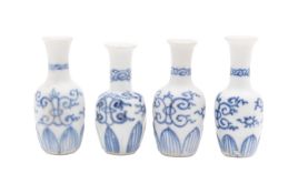 Vung Tau cargo four miniature porcelain 'Dolls House' vases painted with stylised scrolls above a