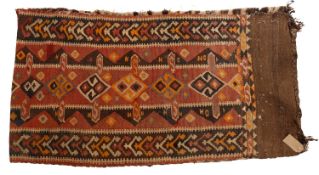 An Anatolian kelim saddle bag, the brick red field with s row of lozenge medallions,
