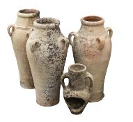 A set of three terracotta jars,