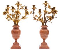 A pair of gilt metal mounted faux marble five-light candelabra in Louis XV taste,