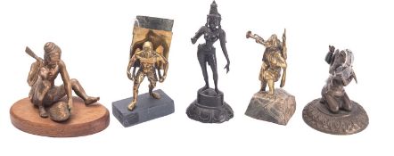 A group of five Asian bronze and brass figures including a seated man chopping a gourd, wood base,