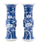 A pair of Chinese blue and white beaker vases [Gu] late 19th century painted with branches of