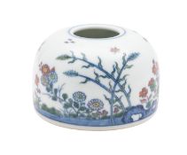 A Chinese doucai beehive water pot painted with rockwork, insects, flowering plants and stems,