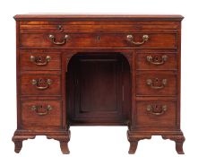 A George III mahogany kneehole desk, late 18th century; the top with moulded edges,