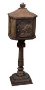 A cast iron post box, early 20th century; modelled as a pavilion,