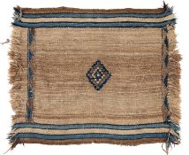 A Kurdish tribal rug, the brown/beige striped field with a central lozenge medallion, having ivory,