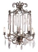 A patinated metal and glass hung eight -light 'cage' chandelier in lantern form,