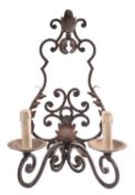 A set of four wrought iron twin-light wall appliques,