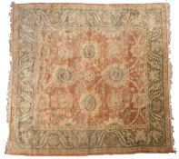 A Turkish carpet, the shaded crimson field with a design of palmettes,