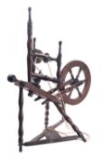 A Regency oak and walnut spinning wheel, early 19th century; with knop and bobbin-turned spokes,